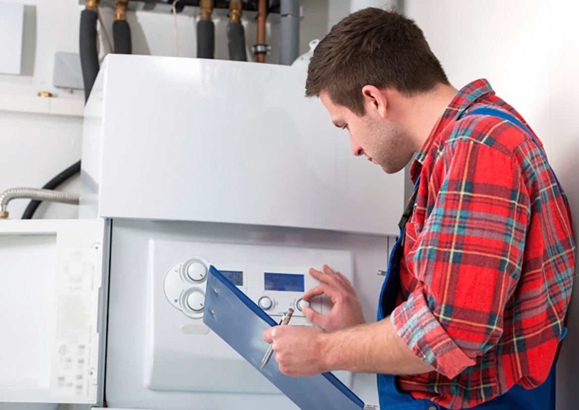 Technician servicing heating boiler